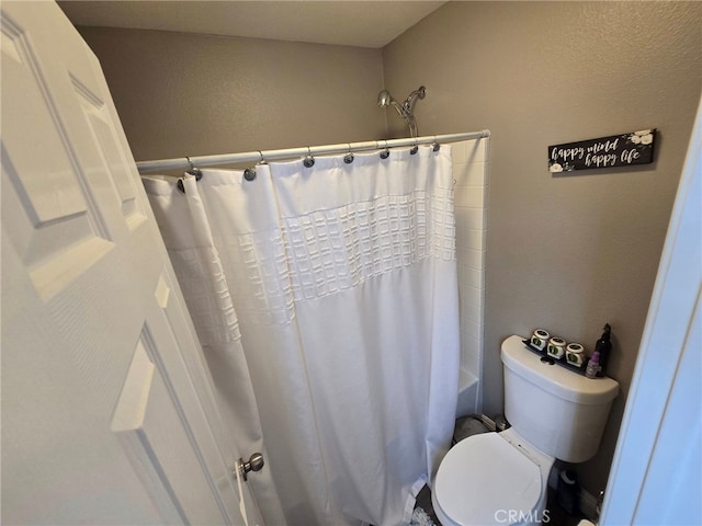 1315 Plaza Way, Perris, CA 92570 - full bathroom featuring a textured wall and shower / bath combo with shower curtain