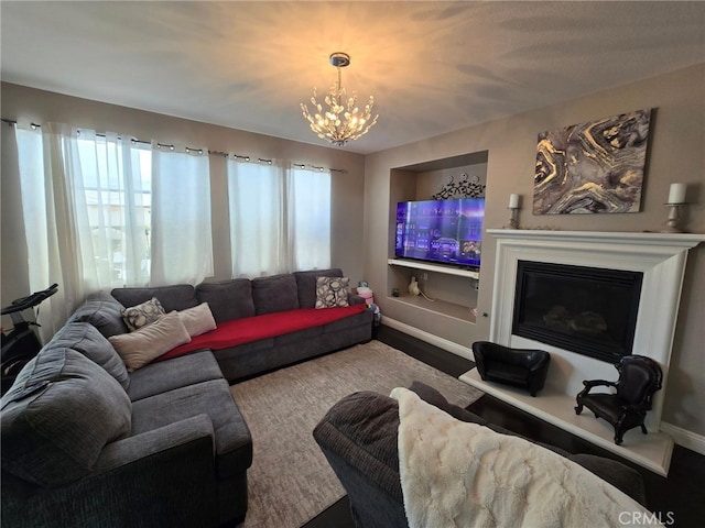 1315 Plaza Way, Perris, CA 92570 - living room featuring plenty of natural light, a chandelier, a glass covered fireplace, and wood finished floors