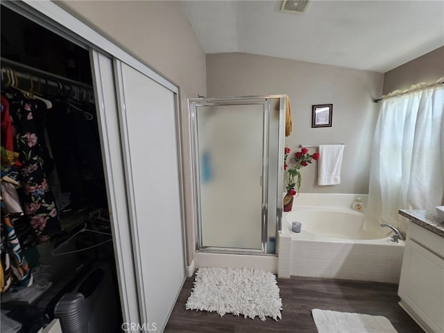 1315 Plaza Way, Perris, CA 92570 - bathroom featuring lofted ceiling, a garden tub, a stall shower, wood finished floors, and vanity
