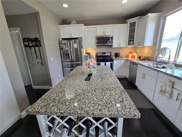 1315 Plaza Way, Perris, CA 92570 - kitchen with stainless steel appliances, a center island, light stone countertops, white cabinets, and recessed lighting