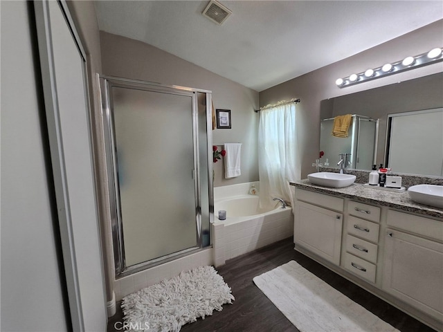1315 Plaza Way, Perris, CA 92570 - bathroom featuring lofted ceiling, a bath, a shower stall, wood finished floors, and double vanity