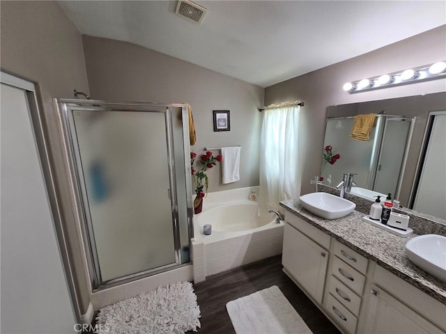 1315 Plaza Way, Perris, CA 92570 - bathroom featuring lofted ceiling, a stall shower, a garden tub, wood finished floors, and double vanity