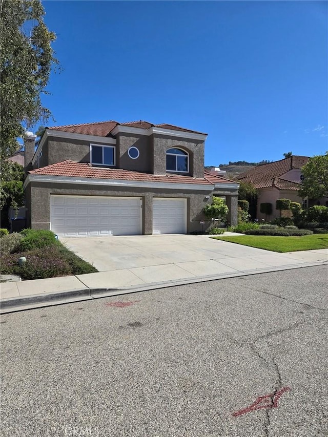 12026 Haven Crest St, Moorpark, CA 93021 - view of front of property featuring concrete driveway, a tiled roof, stucco siding, and an attached garage