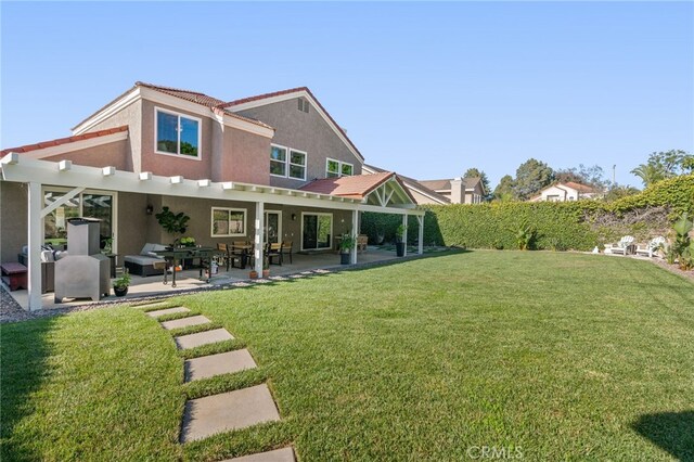 12026 Haven Crest St, Moorpark, CA 93021 - rear view of property featuring stucco siding, a lawn, a patio area, and a pergola