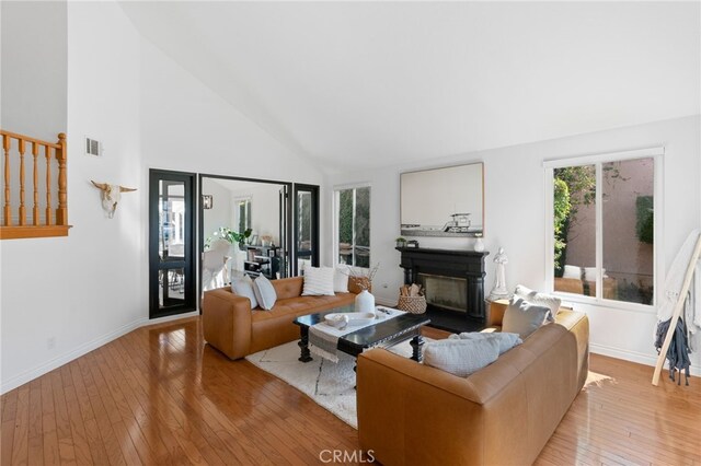 12026 Haven Crest St, Moorpark, CA 93021 - living room with a glass covered fireplace, hardwood / wood-style flooring, and high vaulted ceiling