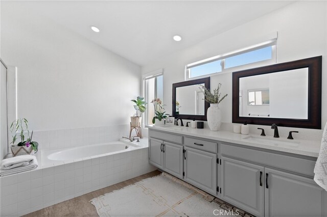 12026 Haven Crest St, Moorpark, CA 93021 - bathroom with double vanity, wood finished floors, and a bath