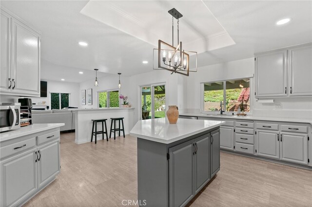12026 Haven Crest St, Moorpark, CA 93021 - kitchen featuring gray cabinets, stainless steel microwave, a center island, light countertops, and recessed lighting