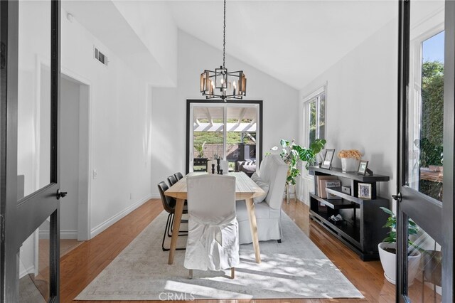 12026 Haven Crest St, Moorpark, CA 93021 - dining space featuring a chandelier, wood finished floors, and high vaulted ceiling