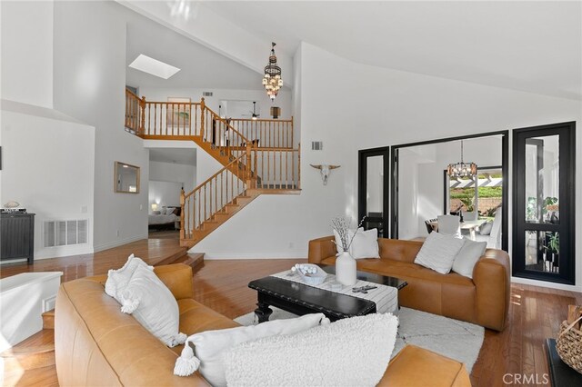 12026 Haven Crest St, Moorpark, CA 93021 - living area with high vaulted ceiling, a chandelier, stairs, wood finished floors, and a skylight
