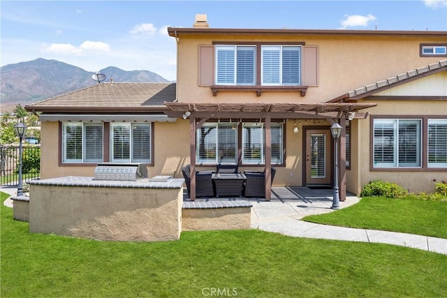 14181 Vai Brothers Dr, Rancho Cucamonga, CA 91739 - rear view of house with a pergola, a patio area, a mountain view, and stucco siding
