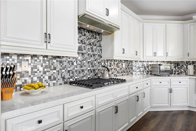 14181 Vai Brothers Dr, Rancho Cucamonga, CA 91739 - kitchen featuring stainless steel gas stovetop, white cabinetry, under cabinet range hood, backsplash, and light stone countertops