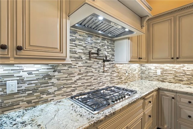 13611 Francisco Dr, Hanford, CA 93230 - kitchen with stainless steel gas stovetop, custom range hood, tasteful backsplash, and light stone counters