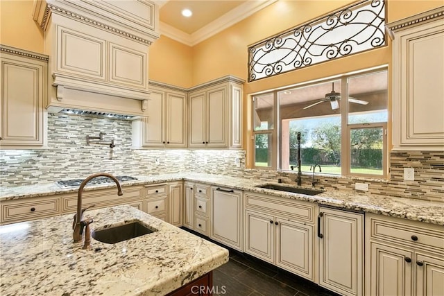 13611 Francisco Dr, Hanford, CA 93230 - kitchen featuring cream cabinetry, stainless steel gas stovetop, tasteful backsplash, light stone counters, and ornamental molding
