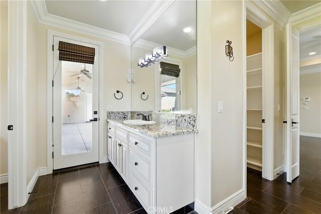 13611 Francisco Dr, Hanford, CA 93230 - bathroom with vanity, crown molding, a spacious closet, and a ceiling fan