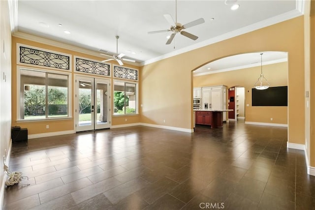 13611 Francisco Dr, Hanford, CA 93230 - unfurnished living room featuring arched walkways, ceiling fan, recessed lighting, and crown molding