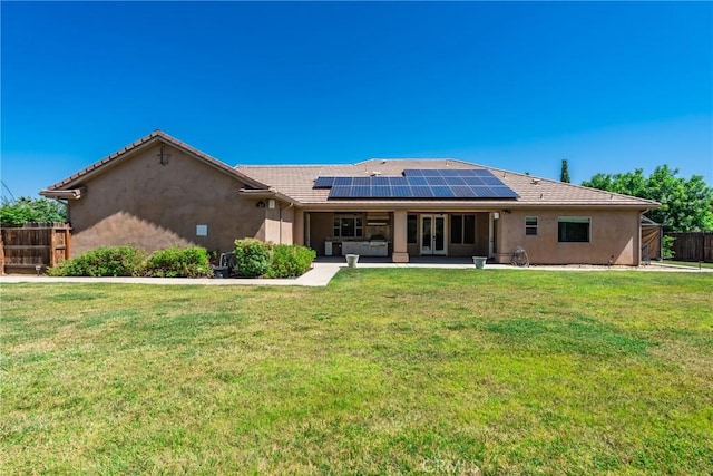 13611 Francisco Dr, Hanford, CA 93230 - back of house featuring roof mounted solar panels, stucco siding, and a patio