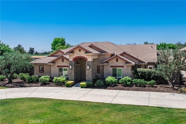 13611 Francisco Dr, Hanford, CA 93230 - view of front of house featuring stucco siding, a tile roof, and a front lawn
