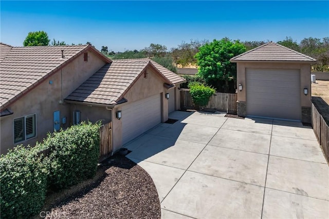13611 Francisco Dr, Hanford, CA 93230 - view of property exterior featuring a tile roof, stucco siding, and a detached garage