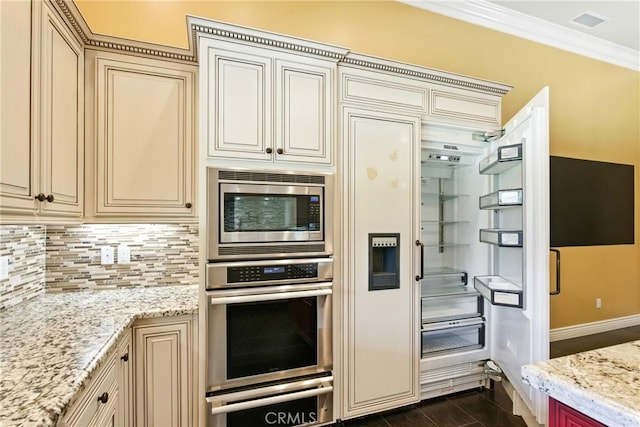 13611 Francisco Dr, Hanford, CA 93230 - kitchen with cream cabinets, stainless steel appliances, decorative backsplash, light stone countertops, and ornamental molding