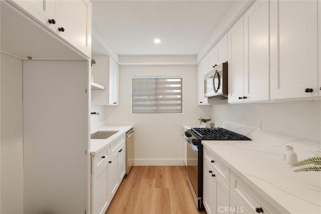 525 E Verdugo Ave Unit E, Burbank, CA 91501 - kitchen with stainless steel appliances, light wood-style floors, light stone countertops, white cabinetry, and recessed lighting