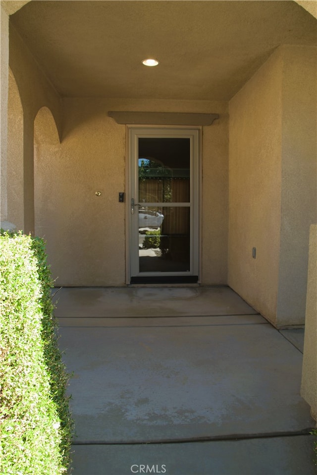 16558 Jasmine St, Victorville, CA 92395 - property entrance with stucco siding and a patio
