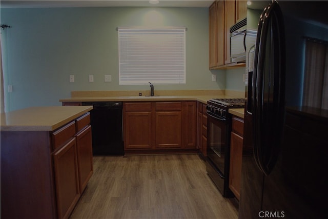 16558 Jasmine St, Victorville, CA 92395 - kitchen featuring black appliances, light wood-style floors, light countertops, recessed lighting, and brown cabinets