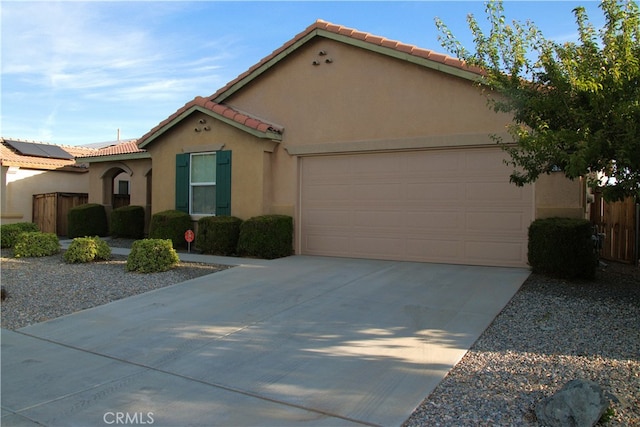16558 Jasmine St, Victorville, CA 92395 - mediterranean / spanish-style house featuring stucco siding, a garage, concrete driveway, and a tile roof