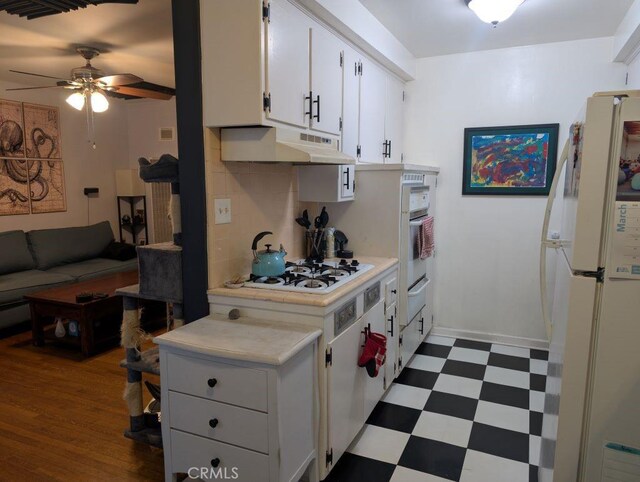 438 Cedar Ave Unit 4, Long Beach, CA 90802 - kitchen with white appliances, under cabinet range hood, dark flooring, ceiling fan, and light countertops