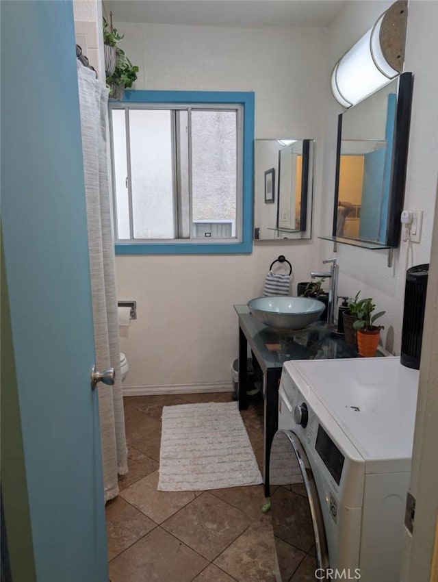 438 Cedar Ave Unit 4, Long Beach, CA 90802 - bathroom featuring tile patterned flooring, washer / clothes dryer, and vanity