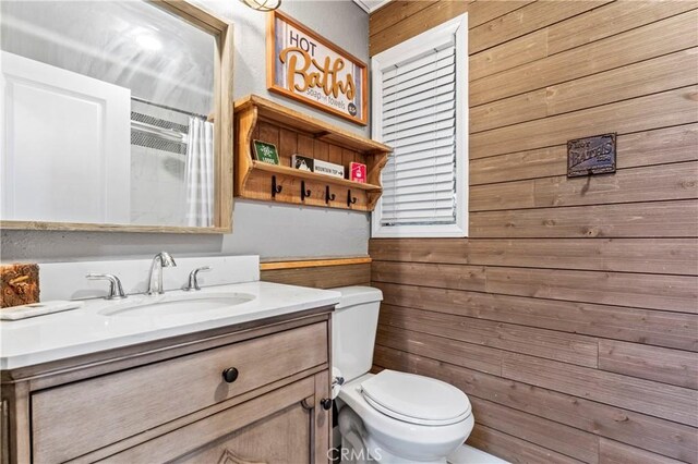 32538 Scandia Dr, Running Springs, CA 92382 - bathroom featuring wooden walls, vanity, and a shower with curtain