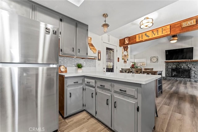 32538 Scandia Dr, Running Springs, CA 92382 - kitchen with freestanding refrigerator, gray cabinetry, and a peninsula