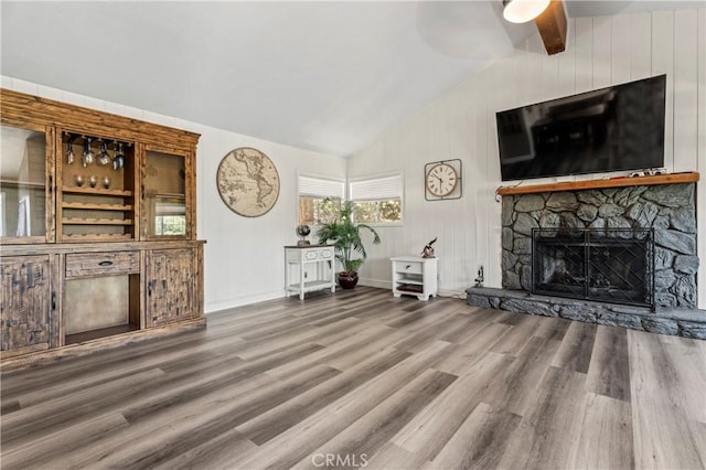 32538 Scandia Dr, Running Springs, CA 92382 - living room with vaulted ceiling, wood finished floors, a ceiling fan, and a stone fireplace