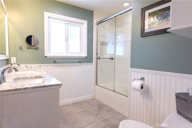 2414 Niagara Way, Costa Mesa, CA 92626 - bathroom featuring a wainscoted wall, shower / bath combination with glass door, double vanity, and tile patterned floors