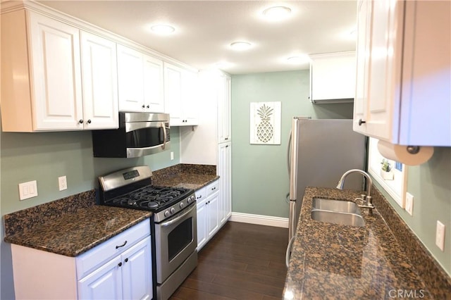2414 Niagara Way, Costa Mesa, CA 92626 - kitchen with appliances with stainless steel finishes, dark wood finished floors, white cabinetry, and dark stone countertops