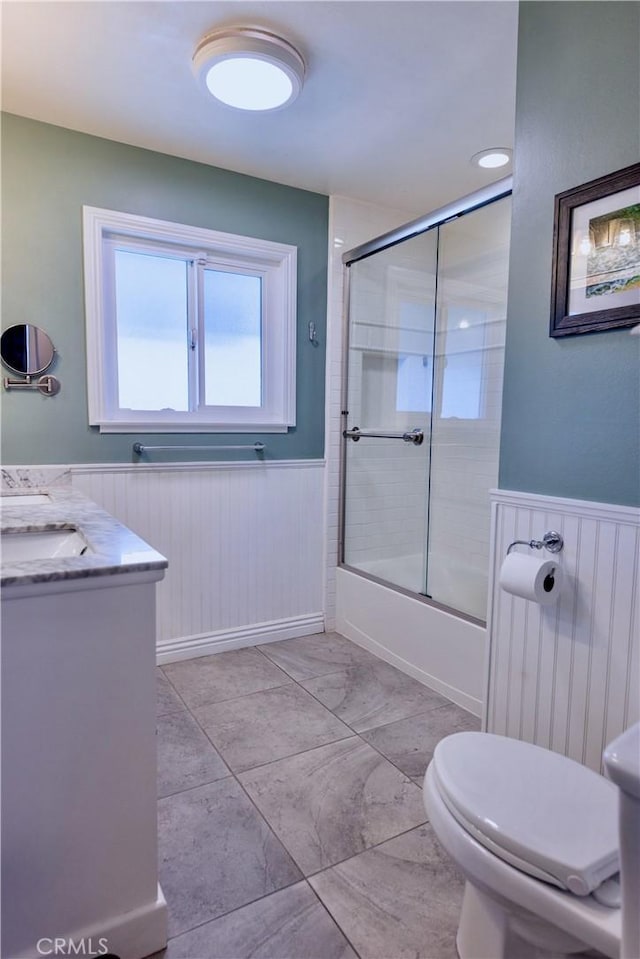 2414 Niagara Way, Costa Mesa, CA 92626 - bathroom featuring a wainscoted wall, shower / bath combination with glass door, and vanity
