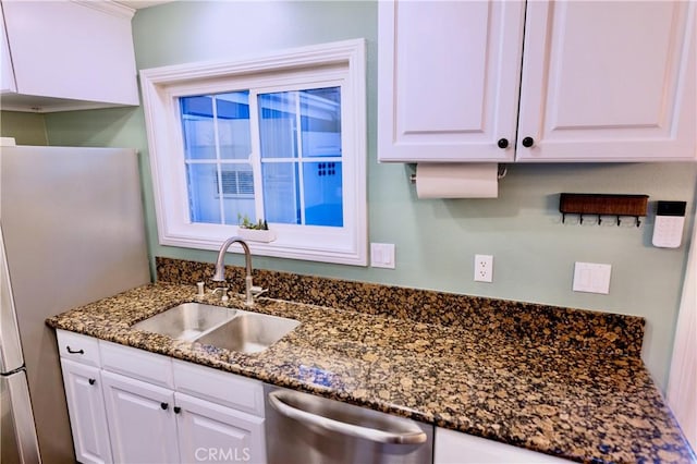2414 Niagara Way, Costa Mesa, CA 92626 - kitchen featuring stainless steel dishwasher, white cabinets, freestanding refrigerator, and dark stone countertops