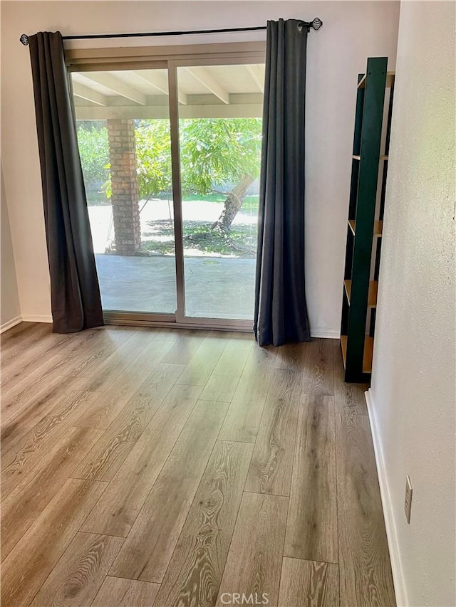 13842 Olive St, Baldwin Park, CA 91706 - spare room with wood finished floors and baseboards