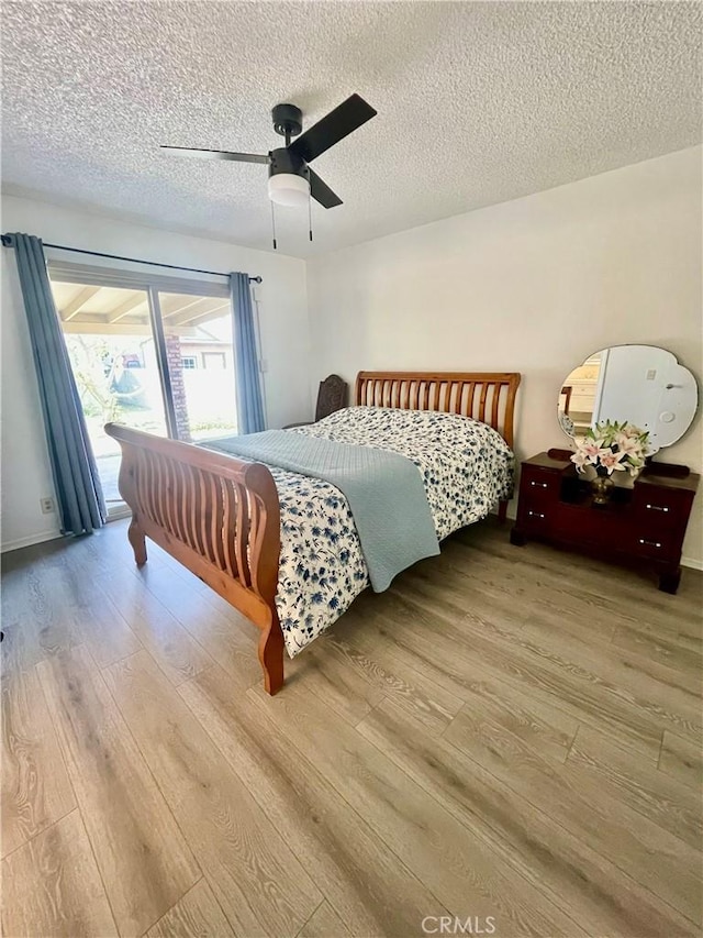 13842 Olive St, Baldwin Park, CA 91706 - bedroom with wood finished floors, access to outside, a textured ceiling, and a ceiling fan