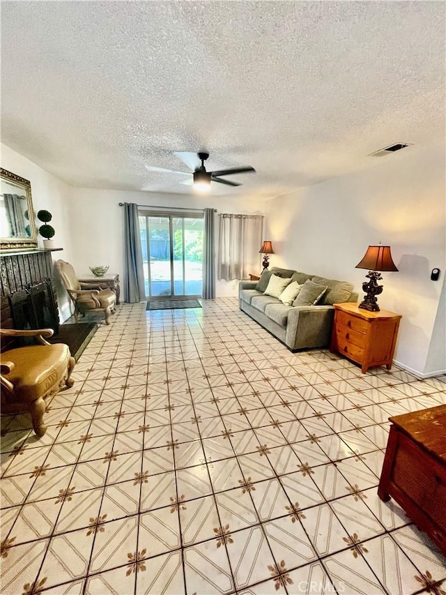 13842 Olive St, Baldwin Park, CA 91706 - living room with a ceiling fan, a textured ceiling, and tile patterned flooring
