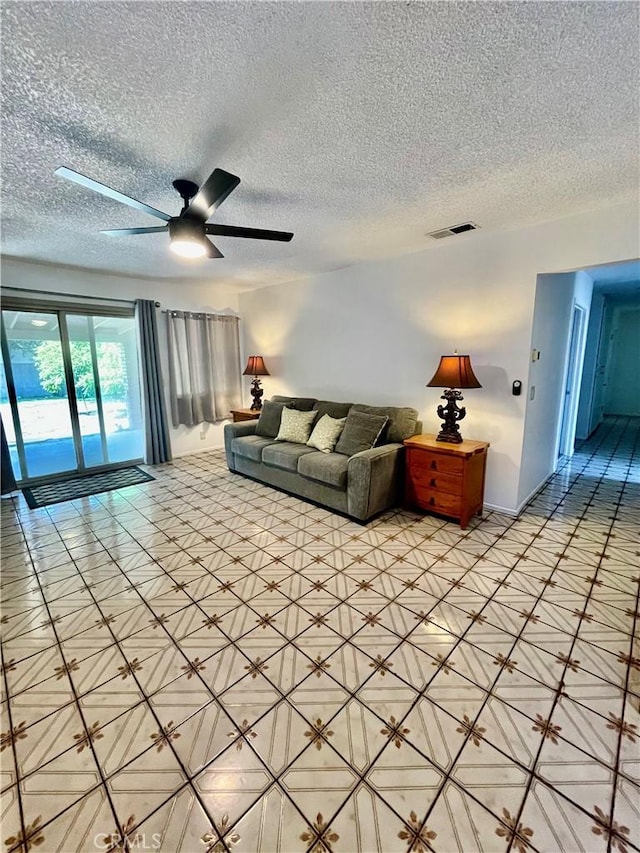 13842 Olive St, Baldwin Park, CA 91706 - living room featuring a textured ceiling, ceiling fan, and light tile patterned floors