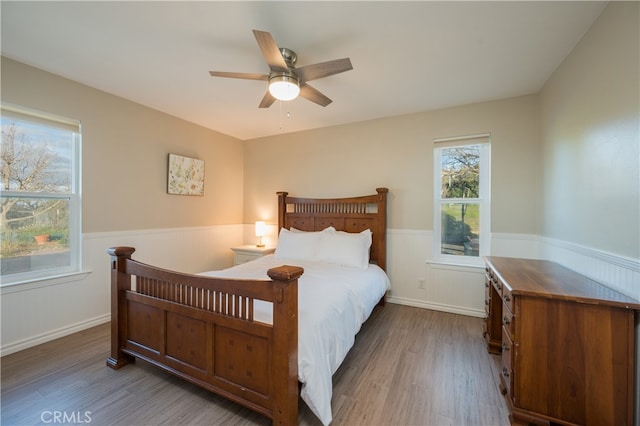 5175 White Tail Pl, Paso Robles, CA 93446 - bedroom with a wainscoted wall, wood finished floors, and ceiling fan