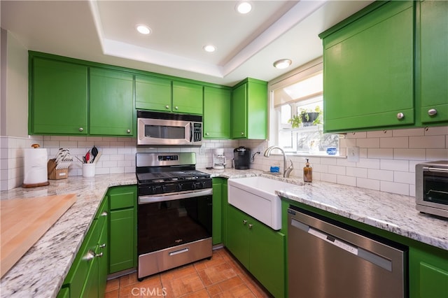 5175 White Tail Pl, Paso Robles, CA 93446 - kitchen featuring appliances with stainless steel finishes, backsplash, recessed lighting, a raised ceiling, and light stone countertops