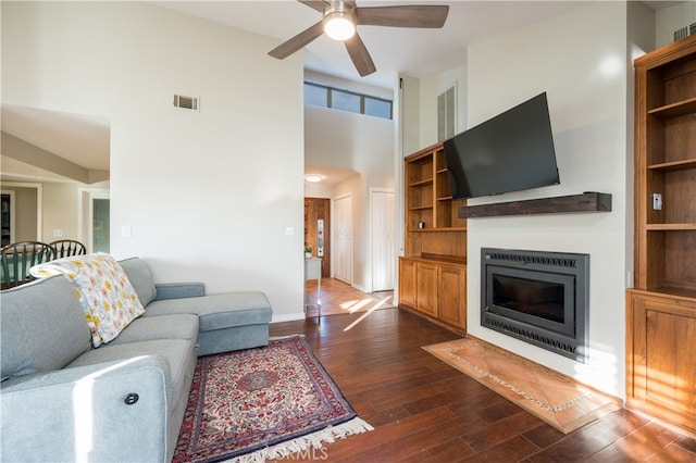 5175 White Tail Pl, Paso Robles, CA 93446 - living room featuring ceiling fan, dark wood-style flooring, a glass covered fireplace, and a high ceiling