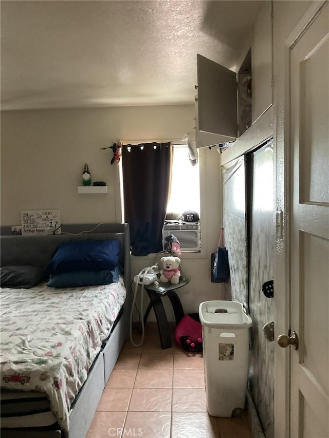 4465 Lovett St, Commerce, CA 90040 - bedroom with light tile patterned flooring, cooling unit, and a textured ceiling