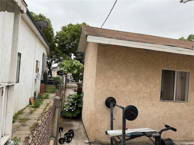 4465 Lovett St, Commerce, CA 90040 - view of side of property with stucco siding and a gate