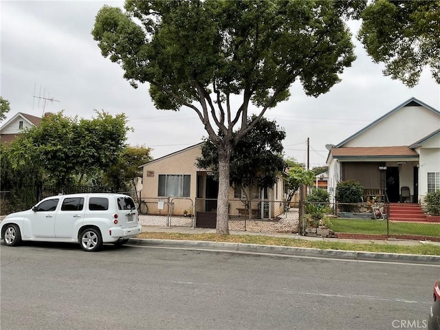 4465 Lovett St, Commerce, CA 90040 - view of front of house with a fenced front yard and stucco siding
