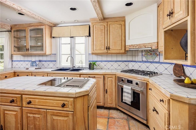 104 Via Lorca, Newport Beach, CA 92663 - kitchen featuring stainless steel appliances, tile counters, tasteful backsplash, glass insert cabinets, and a kitchen island
