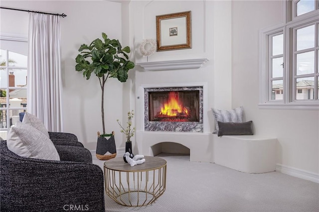 104 Via Lorca, Newport Beach, CA 92663 - living area featuring a warm lit fireplace and carpet floors