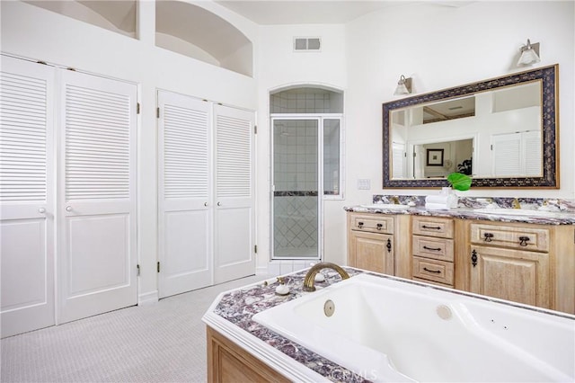 104 Via Lorca, Newport Beach, CA 92663 - bathroom with a closet, a jetted tub, double vanity, and a stall shower