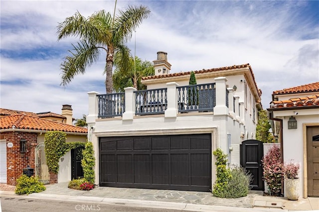 104 Via Lorca, Newport Beach, CA 92663 - mediterranean / spanish home with a balcony, an attached garage, stucco siding, a gate, and a tiled roof